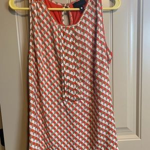 Woman’s sleeveless orange shirt